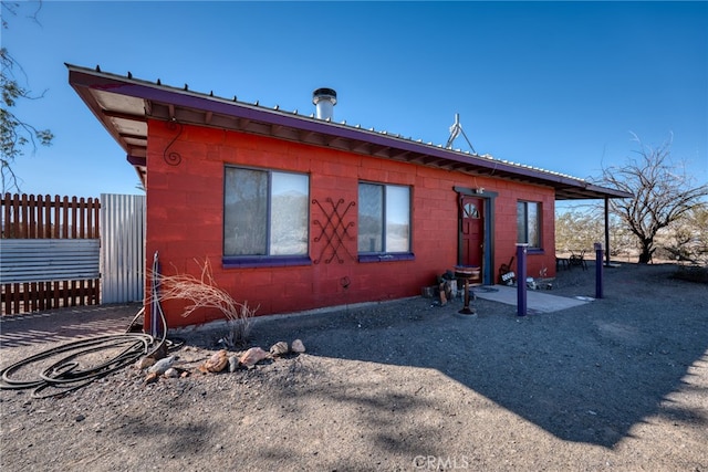 view of side of home with a patio