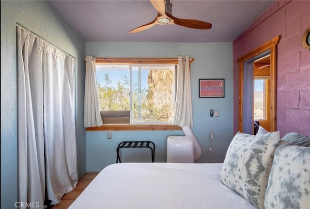 bedroom featuring ceiling fan and multiple windows