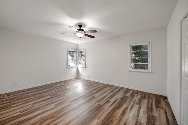 spare room with ceiling fan and wood-type flooring