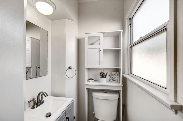 bathroom with vanity, a healthy amount of sunlight, and toilet