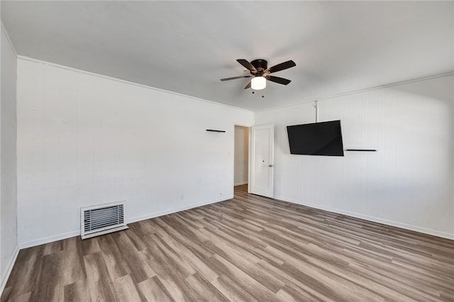 unfurnished room featuring ceiling fan, light hardwood / wood-style floors, and crown molding