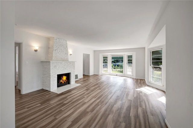 unfurnished living room with a fireplace and hardwood / wood-style flooring