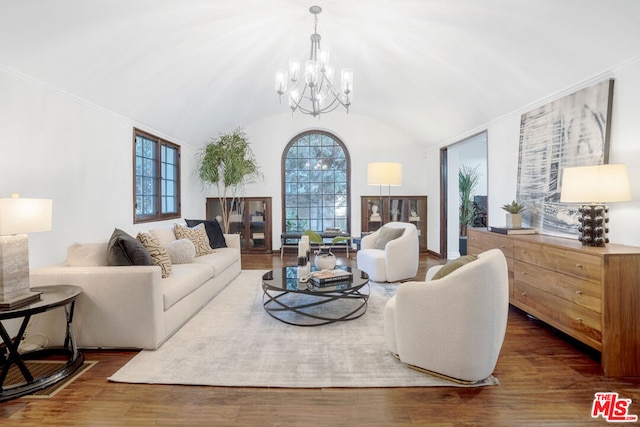 living room with dark wood-type flooring, lofted ceiling, and an inviting chandelier