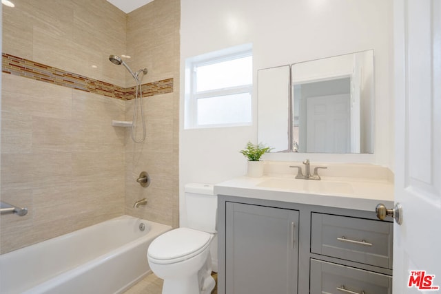 full bathroom with tiled shower / bath combo, toilet, and vanity