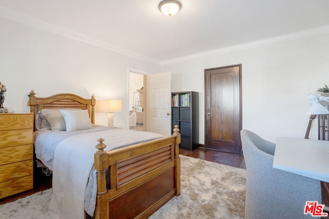 bedroom featuring dark hardwood / wood-style flooring and crown molding