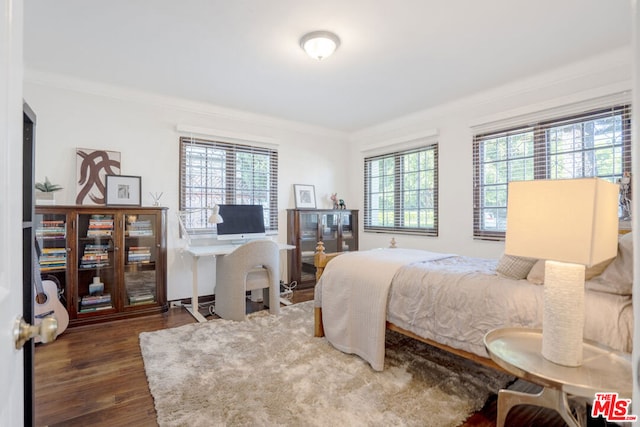 bedroom featuring dark hardwood / wood-style floors and ornamental molding