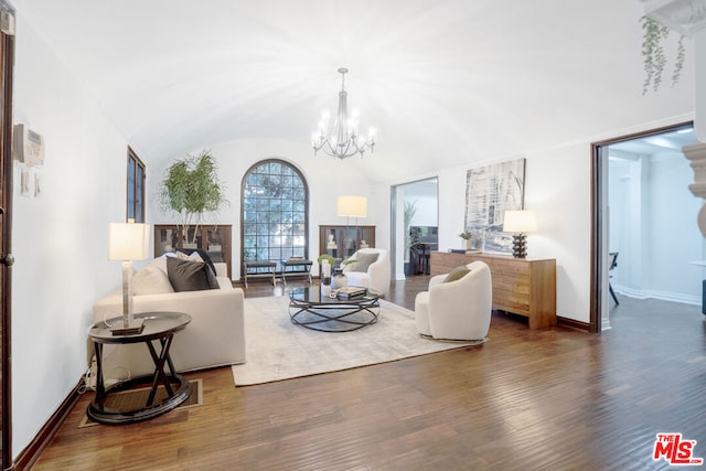 living room with dark hardwood / wood-style flooring, vaulted ceiling, and an inviting chandelier