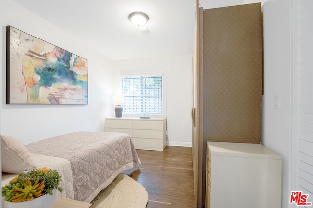 bedroom with dark hardwood / wood-style flooring