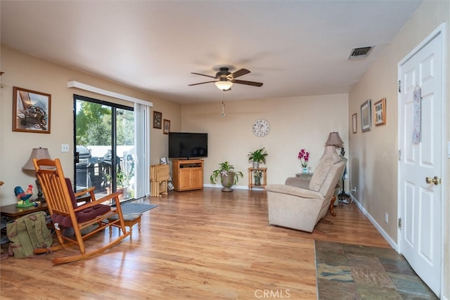 living room featuring ceiling fan and wood-type flooring