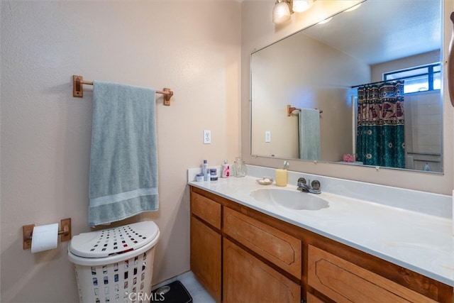 bathroom featuring vanity, toilet, and curtained shower