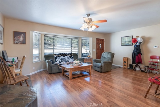 living room featuring hardwood / wood-style floors and ceiling fan