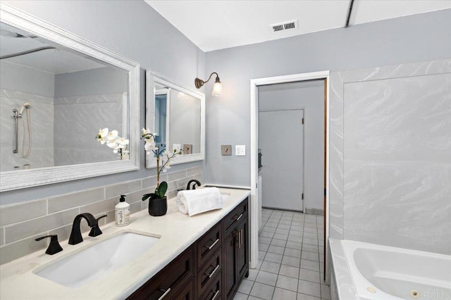 bathroom with vanity, tasteful backsplash, and tile patterned floors