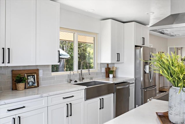 kitchen featuring tasteful backsplash, appliances with stainless steel finishes, exhaust hood, and white cabinets