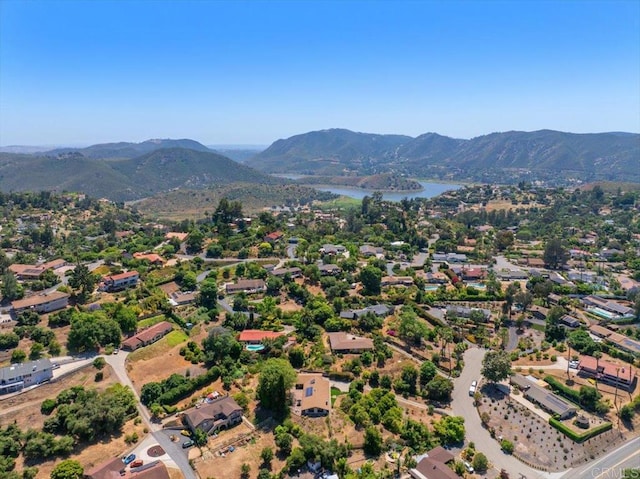 drone / aerial view with a water and mountain view