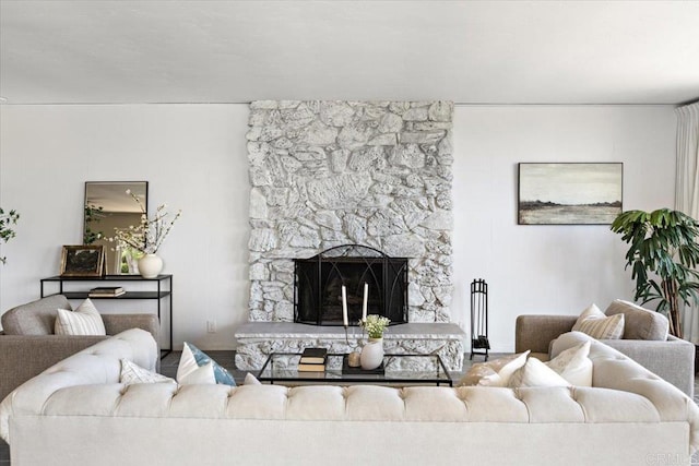 living room with a stone fireplace