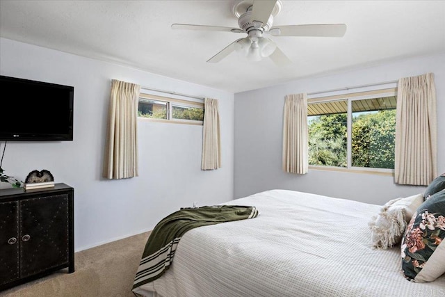 bedroom featuring carpet, multiple windows, and ceiling fan