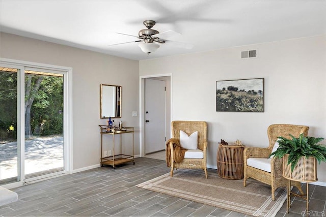 living area with hardwood / wood-style floors and ceiling fan