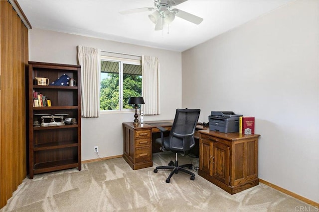 office space featuring light carpet and ceiling fan