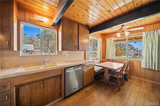 kitchen with tile countertops, dishwasher, light hardwood / wood-style floors, and plenty of natural light