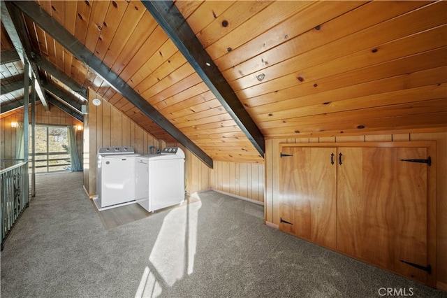 additional living space with washer and dryer, wood walls, and dark carpet