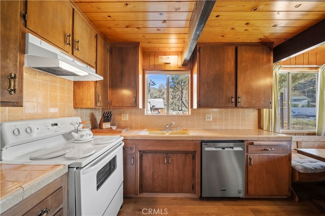 kitchen with electric range, stainless steel dishwasher, dark hardwood / wood-style floors, tile counters, and sink