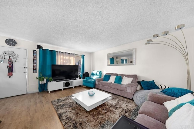 living room with hardwood / wood-style flooring and a textured ceiling