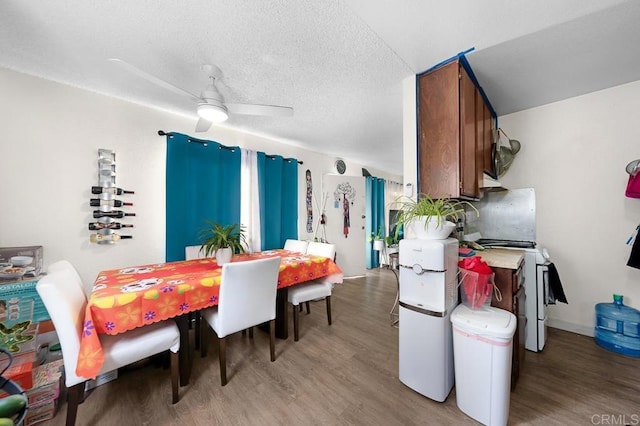 dining space featuring ceiling fan, a textured ceiling, and hardwood / wood-style flooring