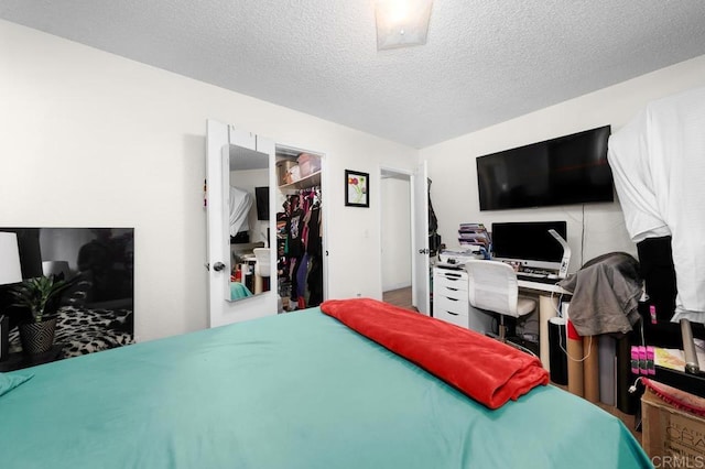 bedroom with a textured ceiling and a closet