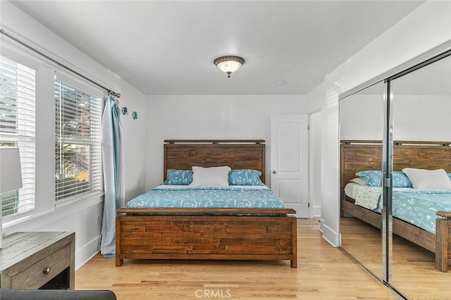 bedroom featuring light hardwood / wood-style floors and a closet