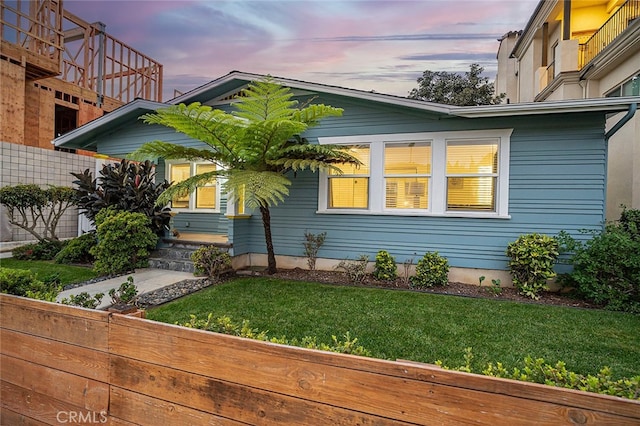 property exterior at dusk with a yard