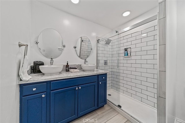 bathroom with vanity and a tile shower