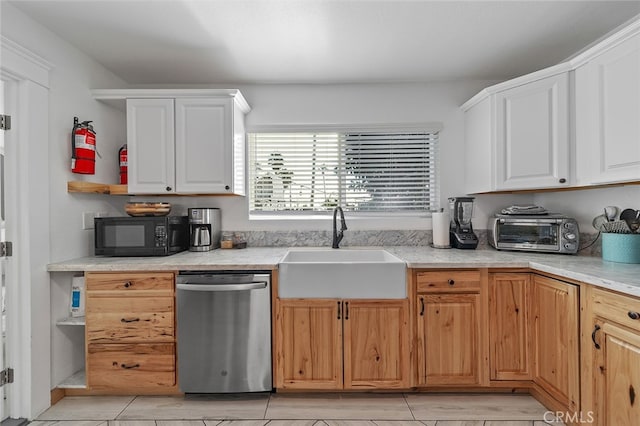 kitchen featuring white cabinetry, sink, and stainless steel dishwasher