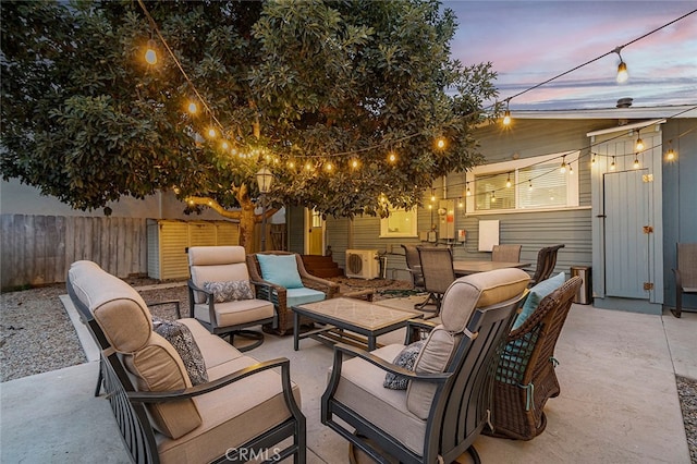 patio terrace at dusk featuring an outdoor living space