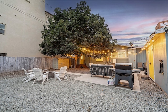 patio terrace at dusk with a fire pit