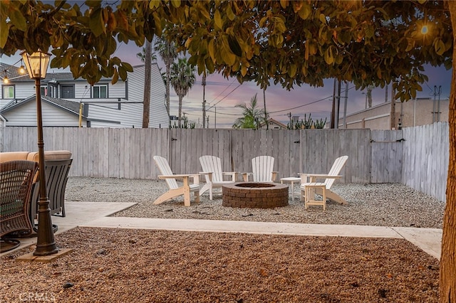 patio terrace at dusk featuring an outdoor fire pit