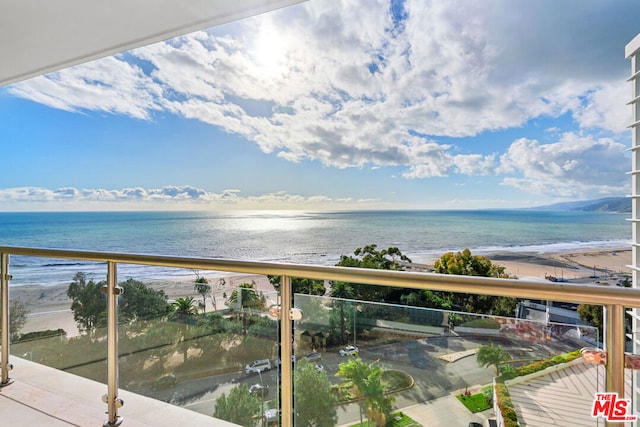 balcony with a view of the beach and a water view