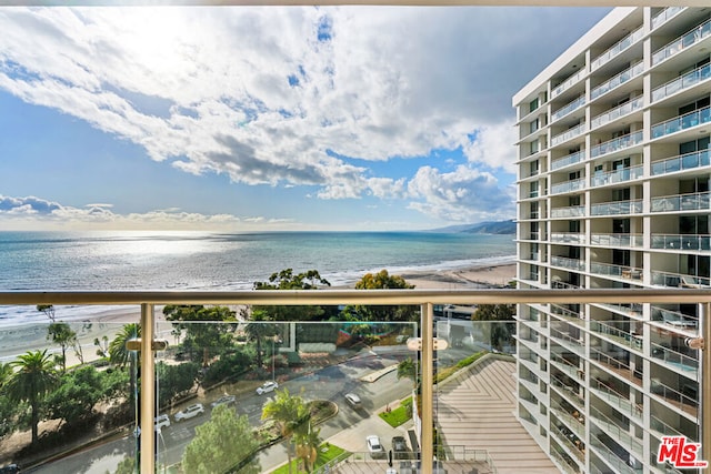 balcony with a beach view and a water view