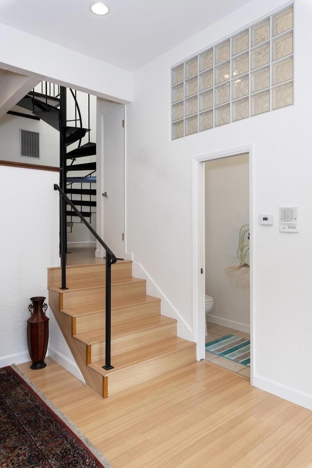 stairs featuring hardwood / wood-style flooring