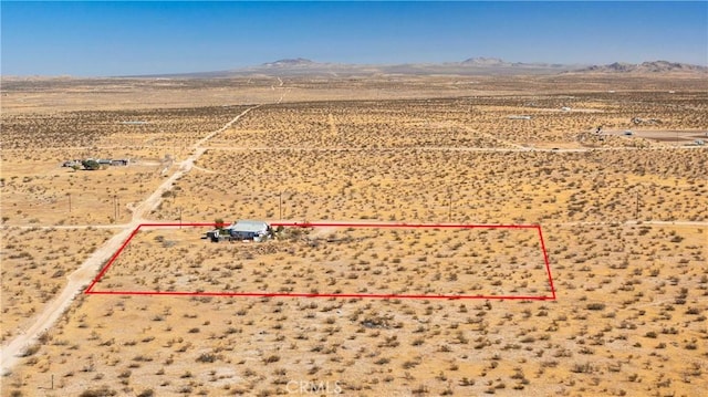 birds eye view of property with a mountain view