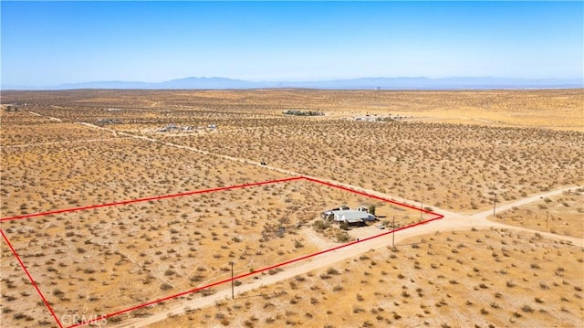 birds eye view of property with a mountain view