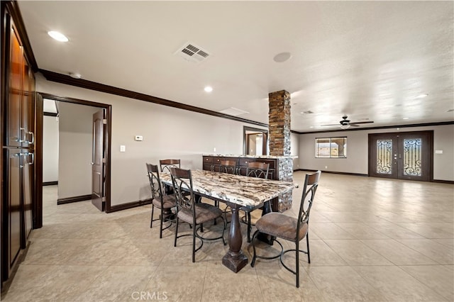 dining area featuring ceiling fan, crown molding, and decorative columns