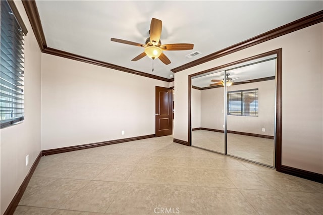 unfurnished bedroom with a closet, crown molding, and ceiling fan