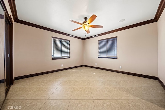 spare room with ornamental molding, light tile patterned floors, and ceiling fan