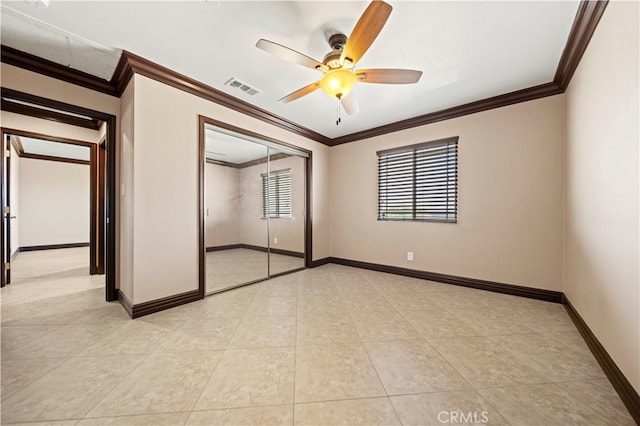 unfurnished bedroom with a closet, ornamental molding, and ceiling fan