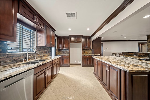 kitchen with tasteful backsplash, sink, light stone counters, stainless steel dishwasher, and crown molding