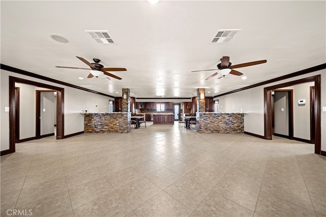 unfurnished living room featuring ornamental molding, ceiling fan, and light tile patterned floors