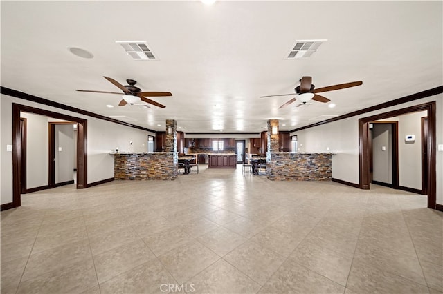 unfurnished living room with ceiling fan, ornamental molding, and light tile patterned floors