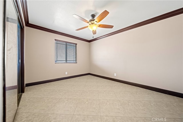 tiled spare room with crown molding and ceiling fan