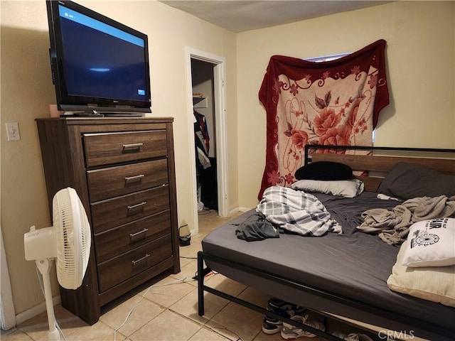 bedroom with a closet and light tile patterned flooring