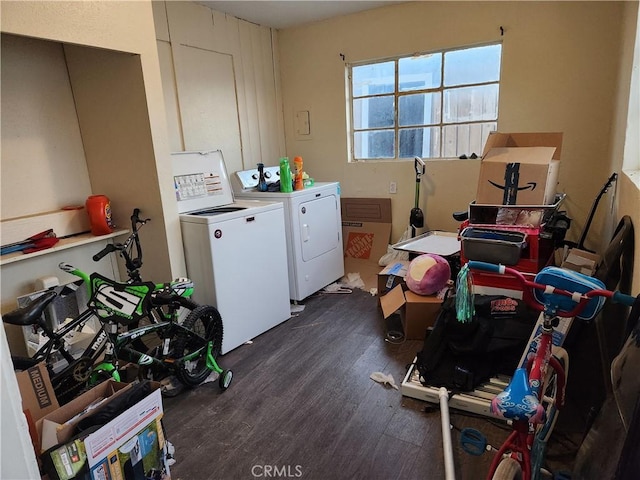 clothes washing area with washing machine and clothes dryer and dark hardwood / wood-style floors